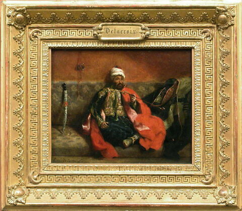 Turc fumant, assis sur un divan, image 2/3
