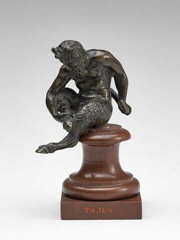 Statuette : petit satyre assis, se tenant la jambe droite
