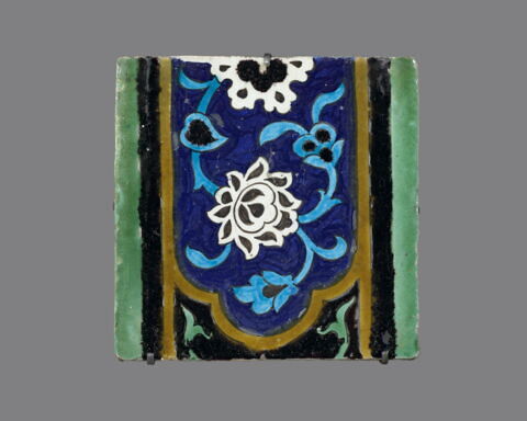 Carreau à décor de cartouche à motifs floraux